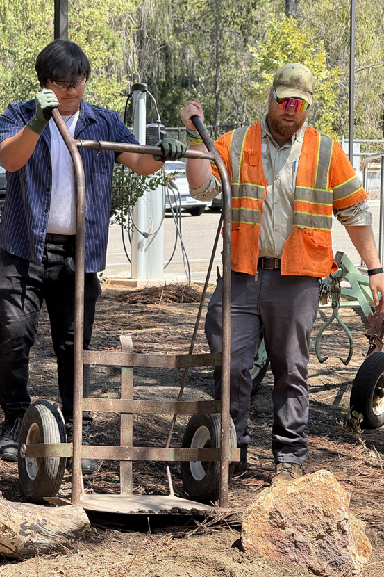 Student moves plants with SDZWA team member